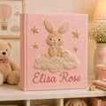 Personalized pink hand embroidered baby photo album with bunny sitting on fluffy clouds and stars