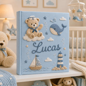 Personalized hand embroidered nautical baby photo album with sailor teddy bear, whale, sailboat, and lighthouse design