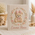 Personalized hand embroidered photo album featuring a classic teddy bear with pink bows and delicate floral embroidery on a linen cover