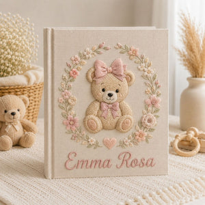 Personalized hand embroidered photo album featuring a classic teddy bear with pink bows and delicate floral embroidery on a linen cover