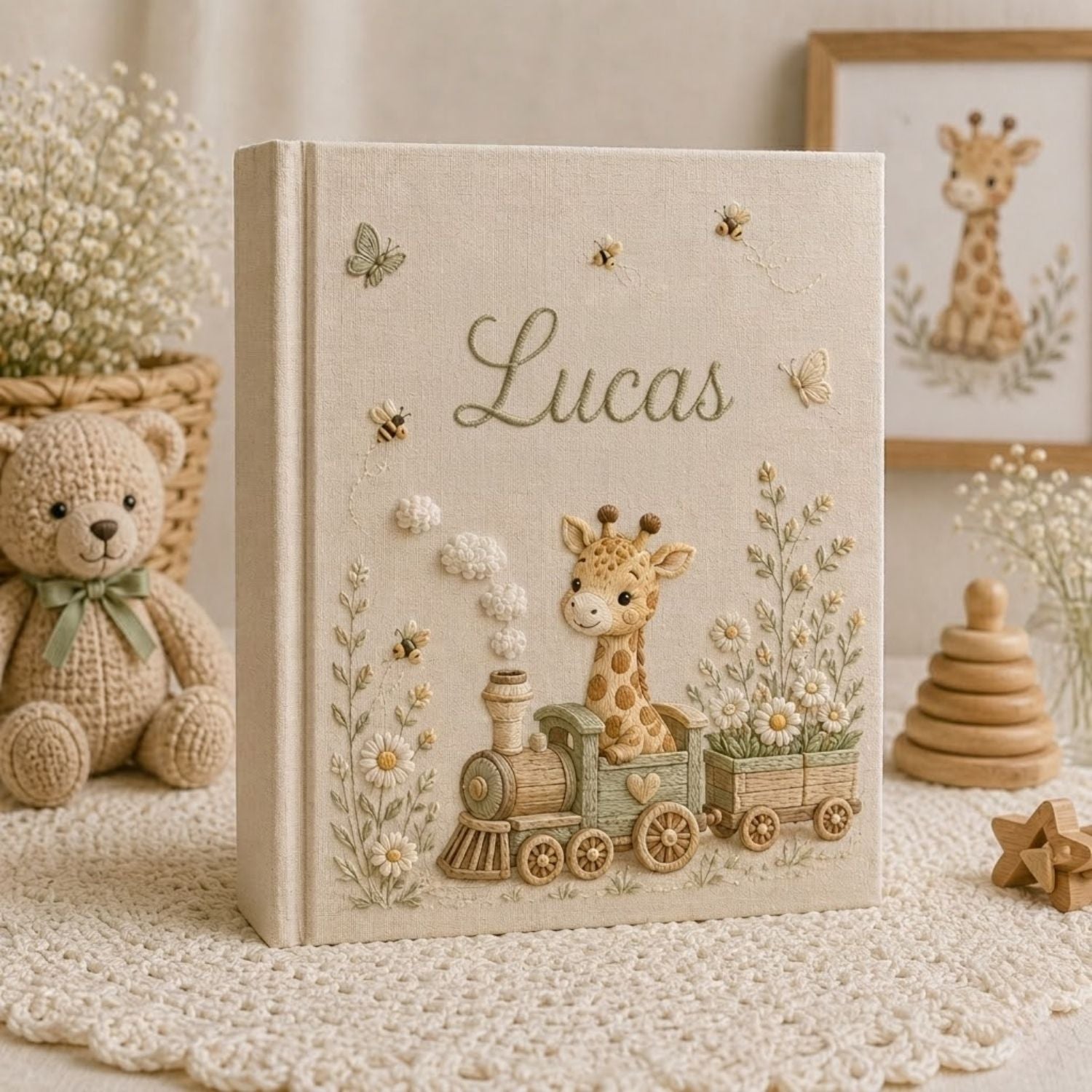 Personalized hand embroidered photo album featuring a baby giraffe riding a vintage train surrounded by daisies, butterflies, and honeybees on a premium linen cover customized with a baby name