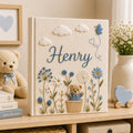 Personalized hand embroidered baby photo album with teddy bear, blue flowers, clouds, and butterfly embroidery details