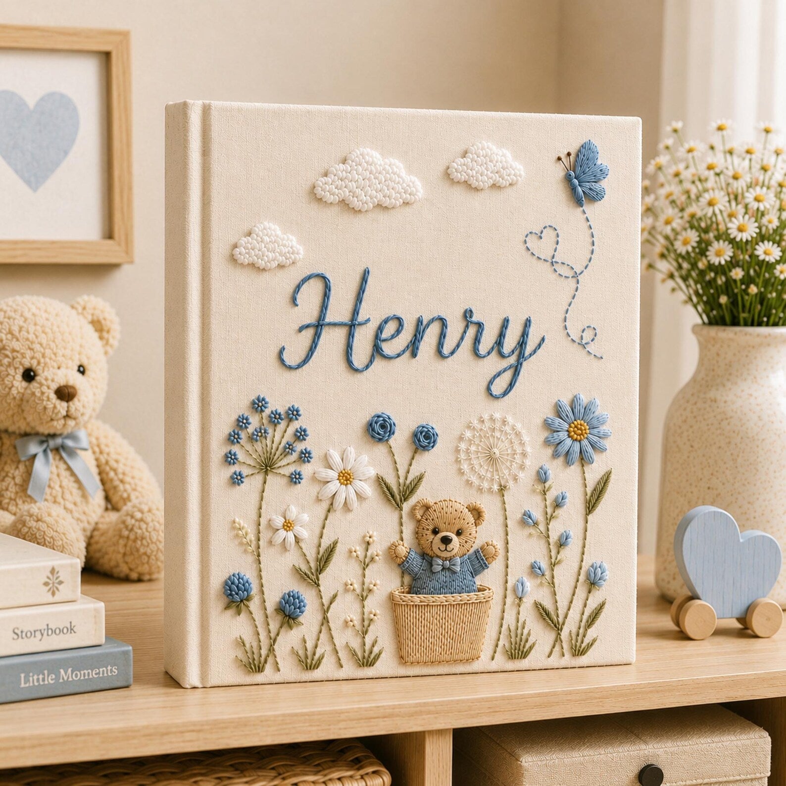 Personalized hand embroidered baby photo album with teddy bear, blue flowers, clouds, and butterfly embroidery details