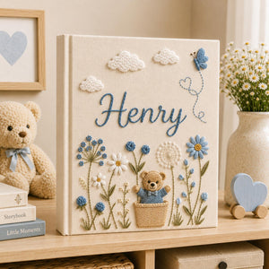 Personalized hand embroidered baby photo album with teddy bear, blue flowers, clouds, and butterfly embroidery details