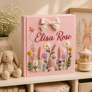 Personalized pink embroidered baby photo album with wildflower meadow design and decorative linen bow