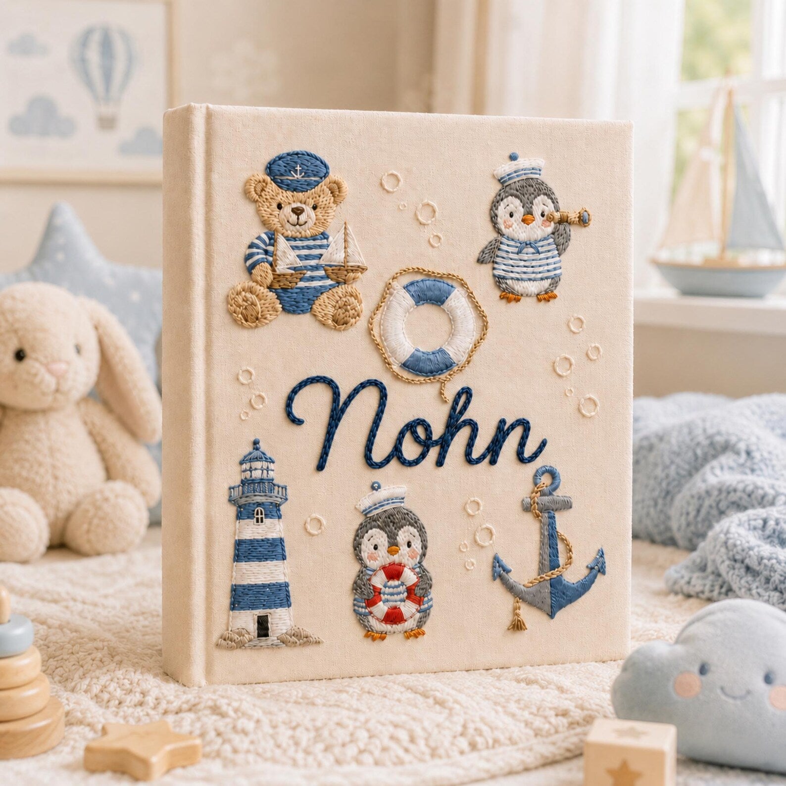 Personalized hand embroidered nautical baby photo album with sailor teddy bear, penguins, lighthouse, and anchor design