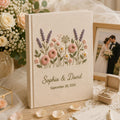 Personalized embroidered wedding photo album with pastel wildflowers, lavender floral embroidery, custom couple names, wedding date, and elegant linen hardcover design