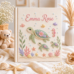 Personalized hand embroidered photo album featuring a sea turtle family with coral reefs, tropical fish, seashells, starfish, and seahorse on a premium linen cover customized with a baby name