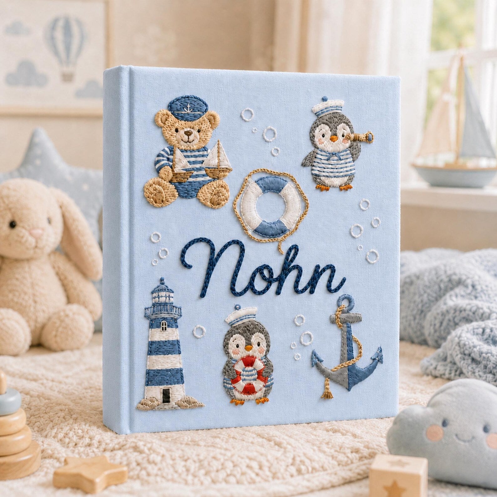 Personalized hand embroidered nautical baby photo album with sailor teddy bear, penguins, lighthouse, and anchor design