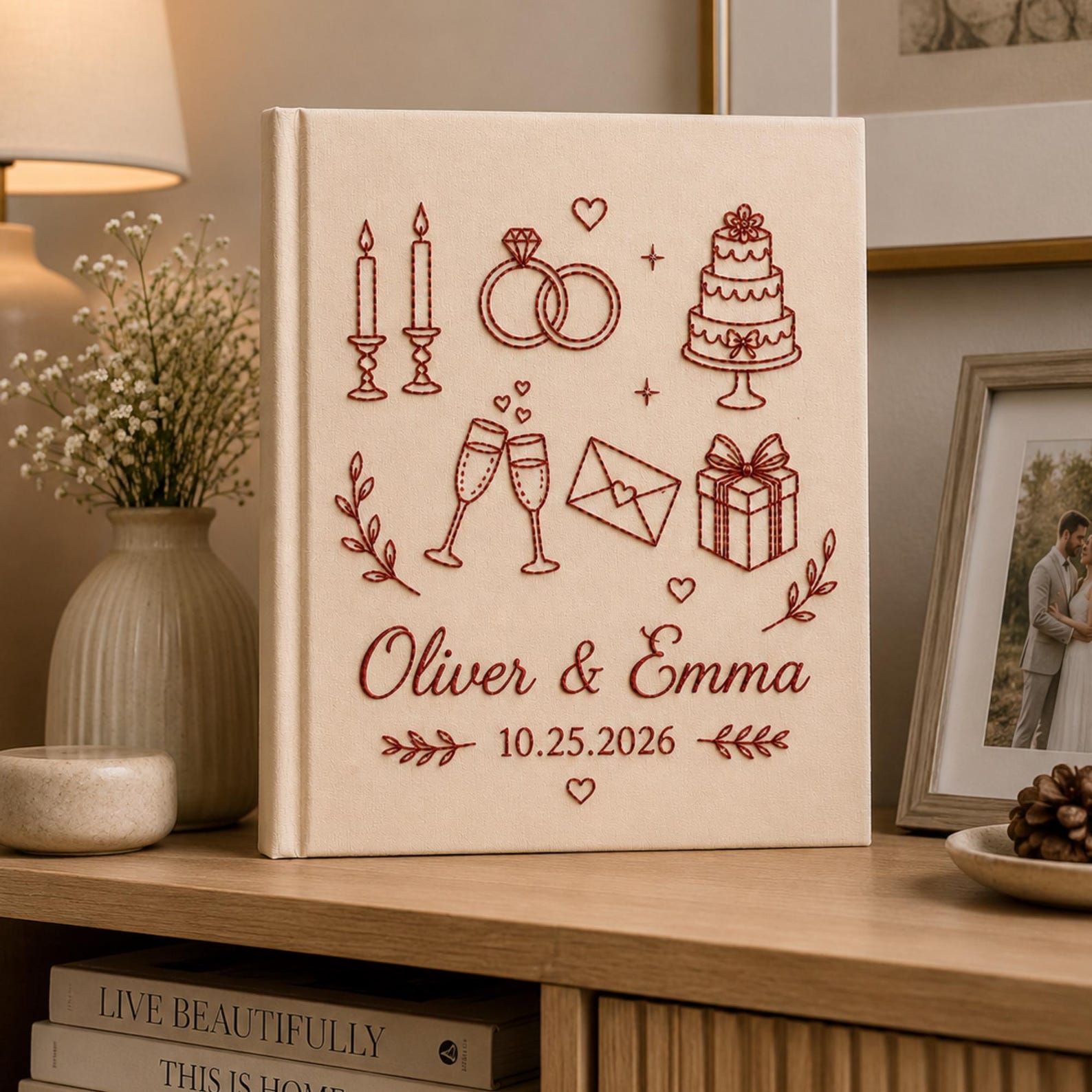 Personalized embroidered wedding photo album with wedding icons rings champagne cake and custom couple names on linen cover