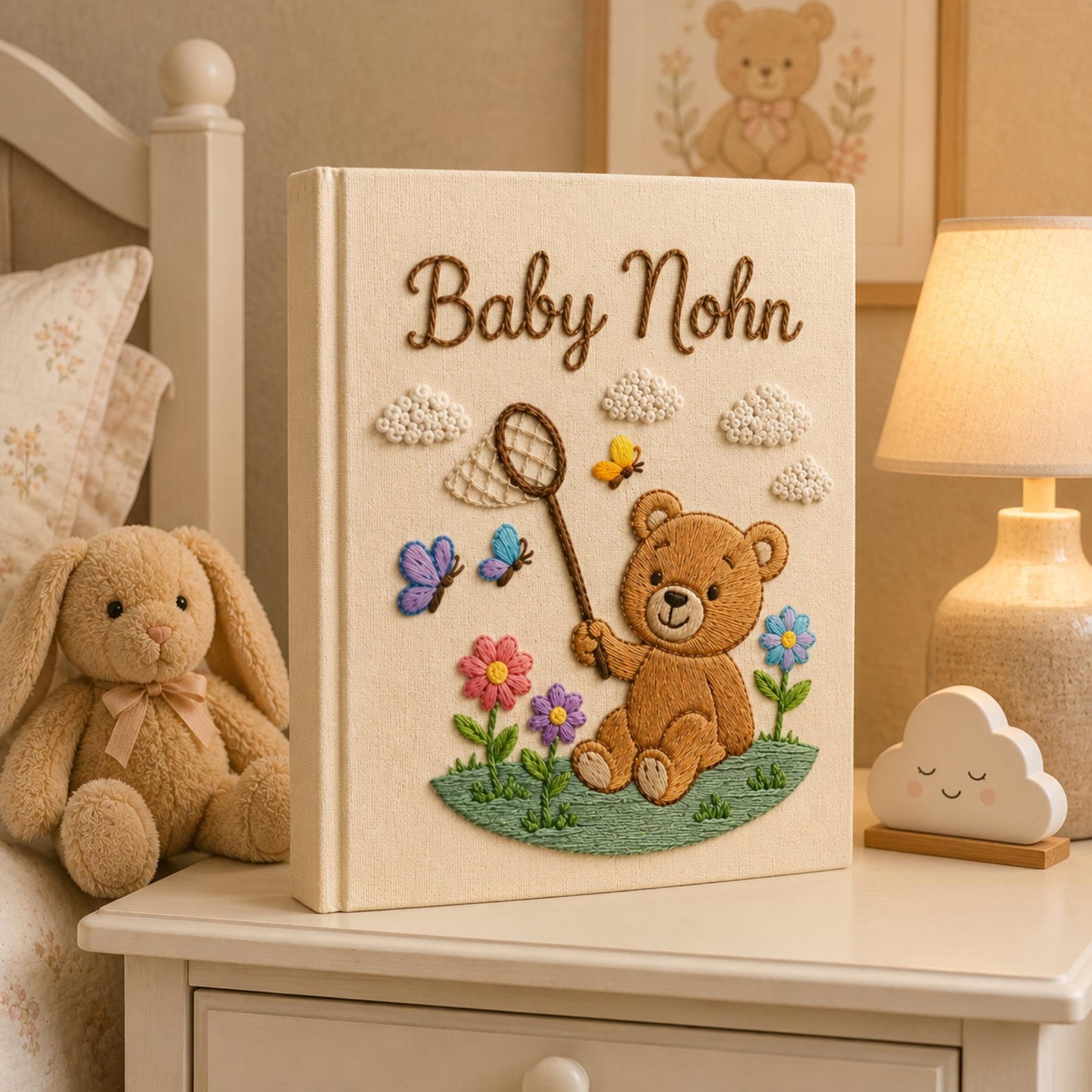 Personalized embroidered baby photo album featuring teddy bear holding butterfly net surrounded by flowers and butterflies