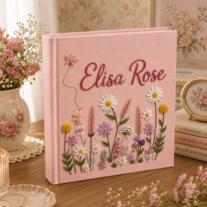 Personalized pink embroidered baby photo album with colorful wildflower garden design and custom name embroidery