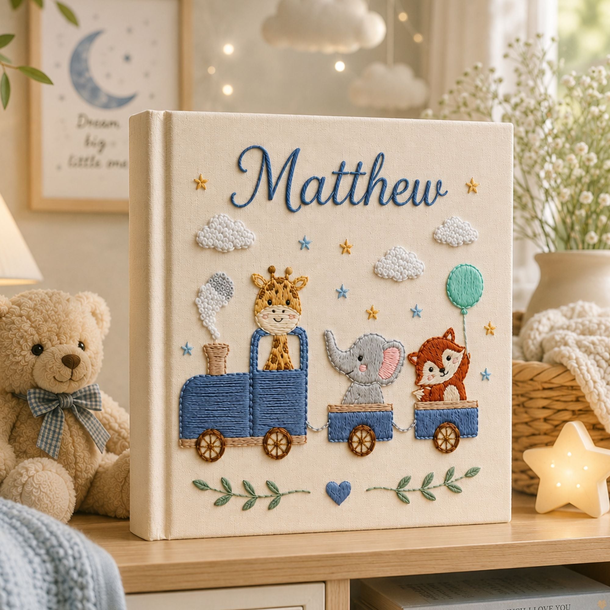 Personalized hand embroidered photo album featuring a safari animal train with giraffe, hippo, lion and zebra on a linen cover