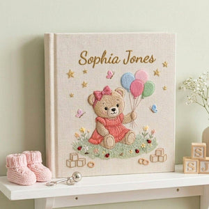 Personalized hand embroidered photo album featuring teddy bear holding pastel balloons surrounded by flowers butterflies and custom baby name