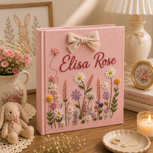 Personalized pink embroidered baby photo album with wildflower meadow design and decorative linen bow