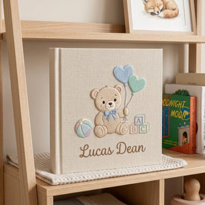 Personalized hand embroidered photo album featuring a teddy bear holding heart-shaped balloons with alphabet blocks and custom baby name