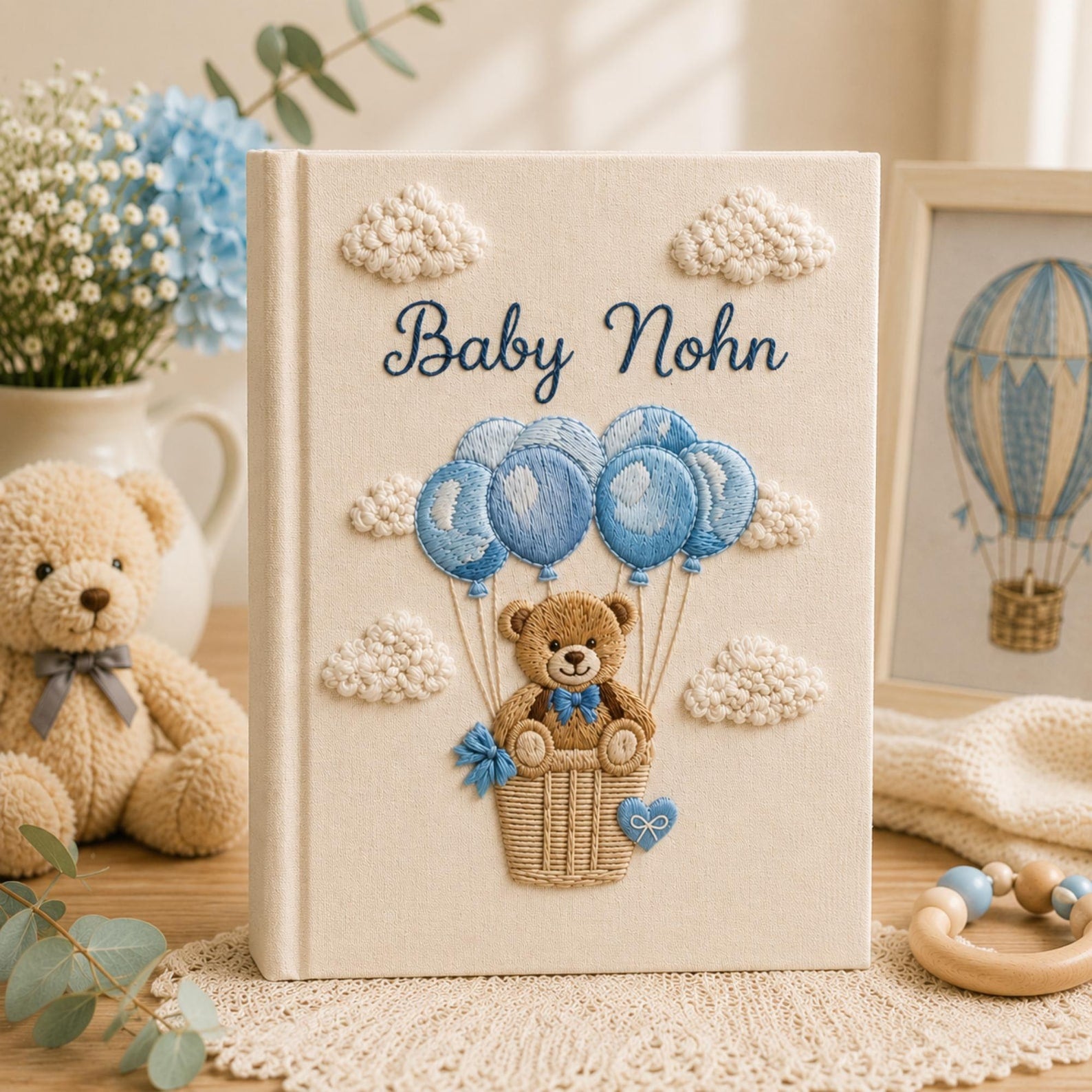 Personalized embroidered baby photo album with teddy bear in balloon basket and blue cloud nursery design