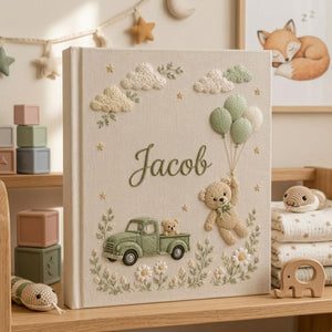 Personalized hand embroidered photo album featuring a vintage sage green pickup truck, floating teddy bear with balloons, clouds, and wildflowers on a premium linen cover customized with a baby name