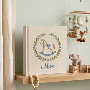 Personalized hand embroidered baby photo album with rocking horse and botanical wreath nursery design