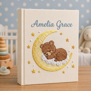 Personalized hand embroidered photo album featuring a sleeping teddy bear resting on a fluffy cloud in a dreamy nursery theme