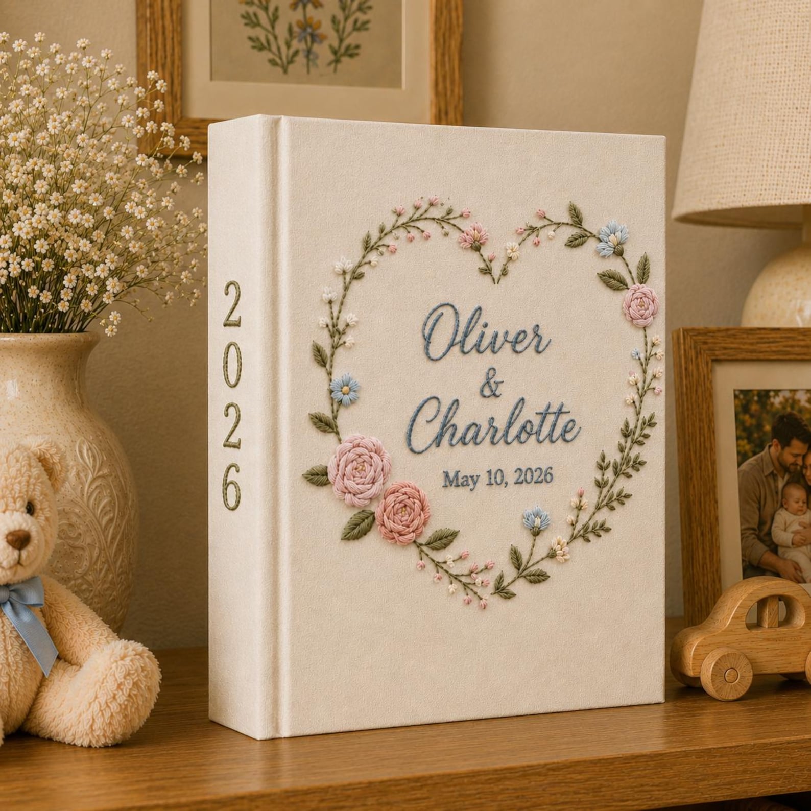 Personalized embroidered wedding photo album with floral heart wreath, pastel flower embroidery, custom names, wedding date, and linen hardcover design