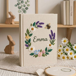 Personalized floral bee hand embroidered baby photo album with lavender daisy wreath design on linen cover