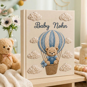Personalized embroidered baby photo album with teddy bear in blue sky balloon basket and fluffy cloud embroidery
