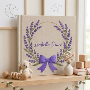 Personalized hand embroidered photo album featuring a lavender floral wreath with an elegant purple bow on a premium linen cover customized with a name