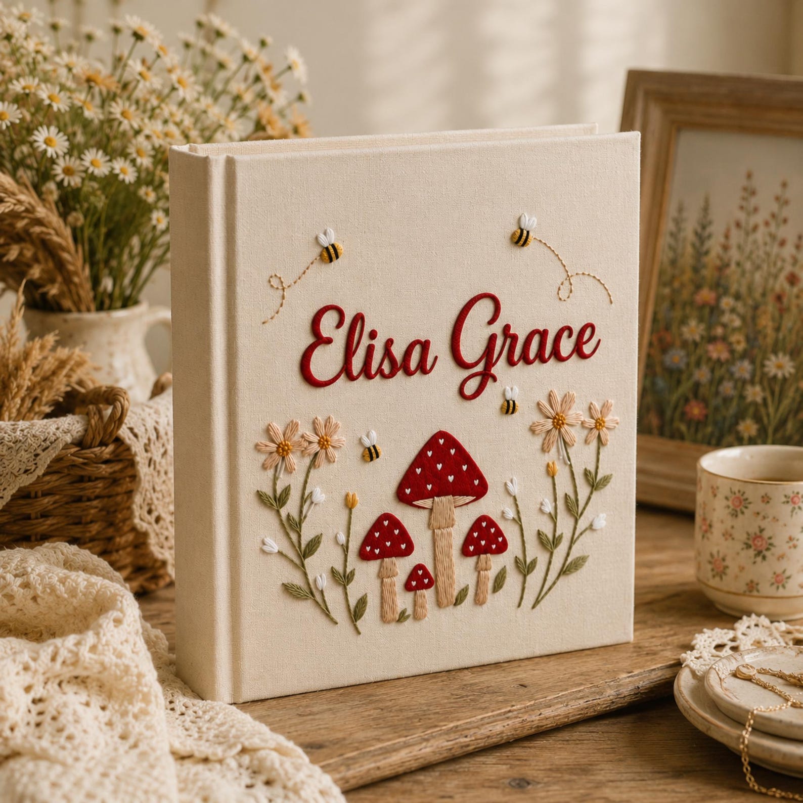 Personalized hand embroidered baby photo album with red mushrooms flowers and bees