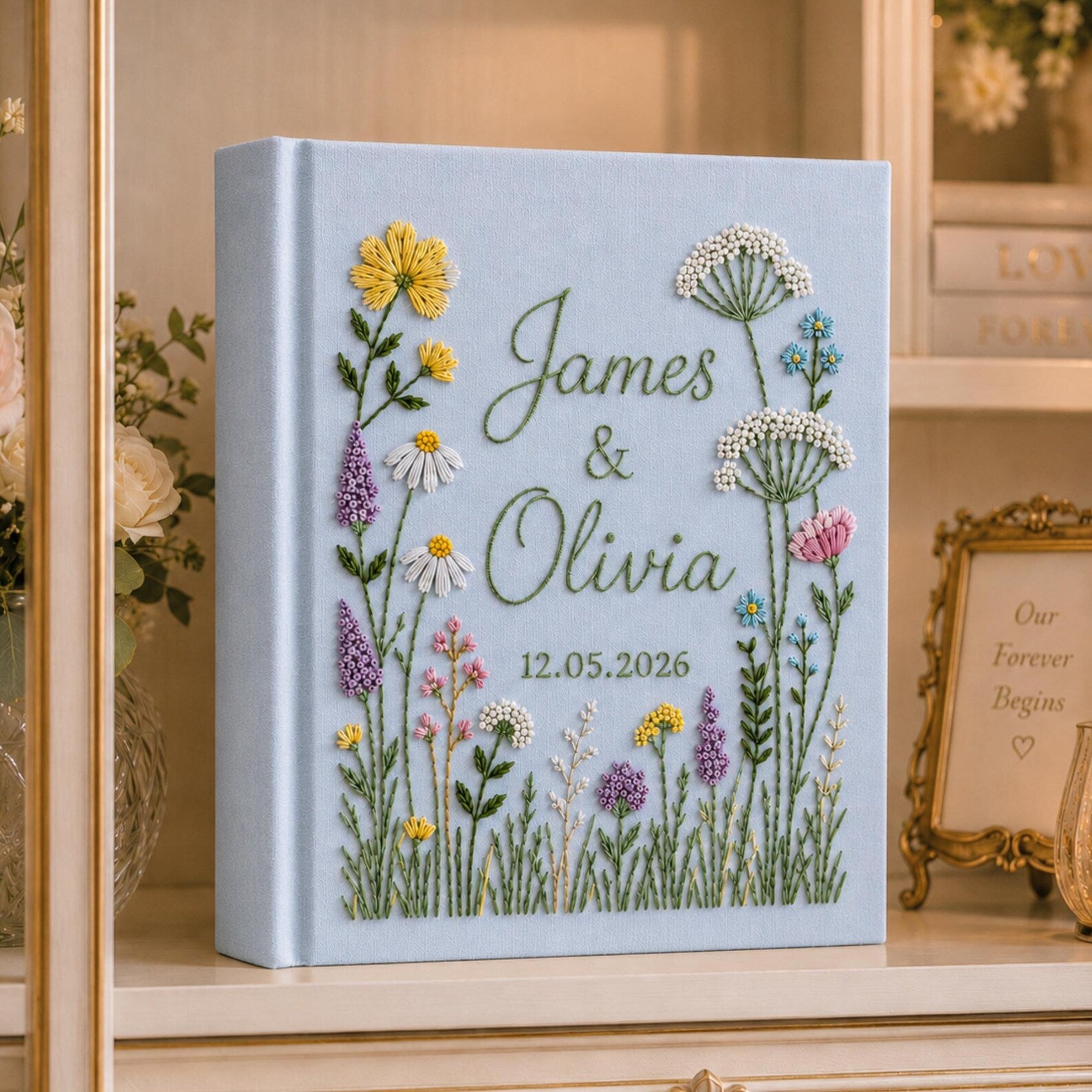 Personalized hand embroidered wild meadow wedding photo album with colorful botanical flowers and custom names on linen cover