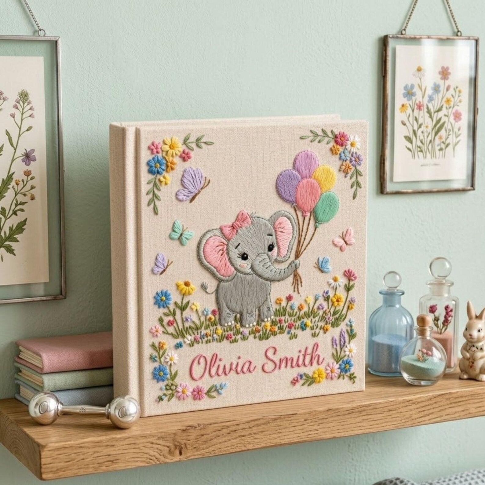 Personalized hand embroidered photo album featuring cute elephant holding colorful balloons surrounded by flowers butterflies and custom name embroidery