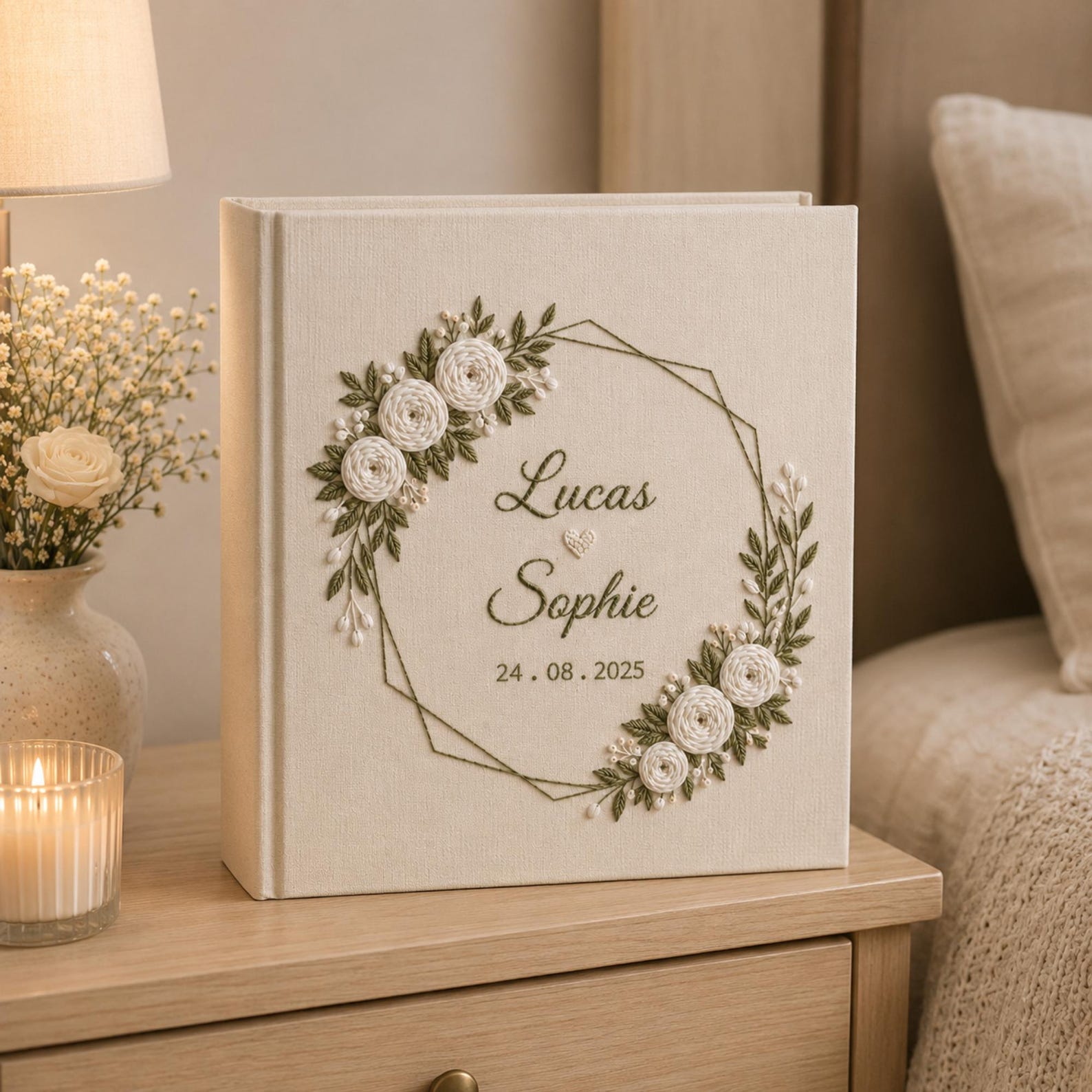 Personalized embroidered wedding photo album with white roses geometric floral wreath and custom couple names on linen cover