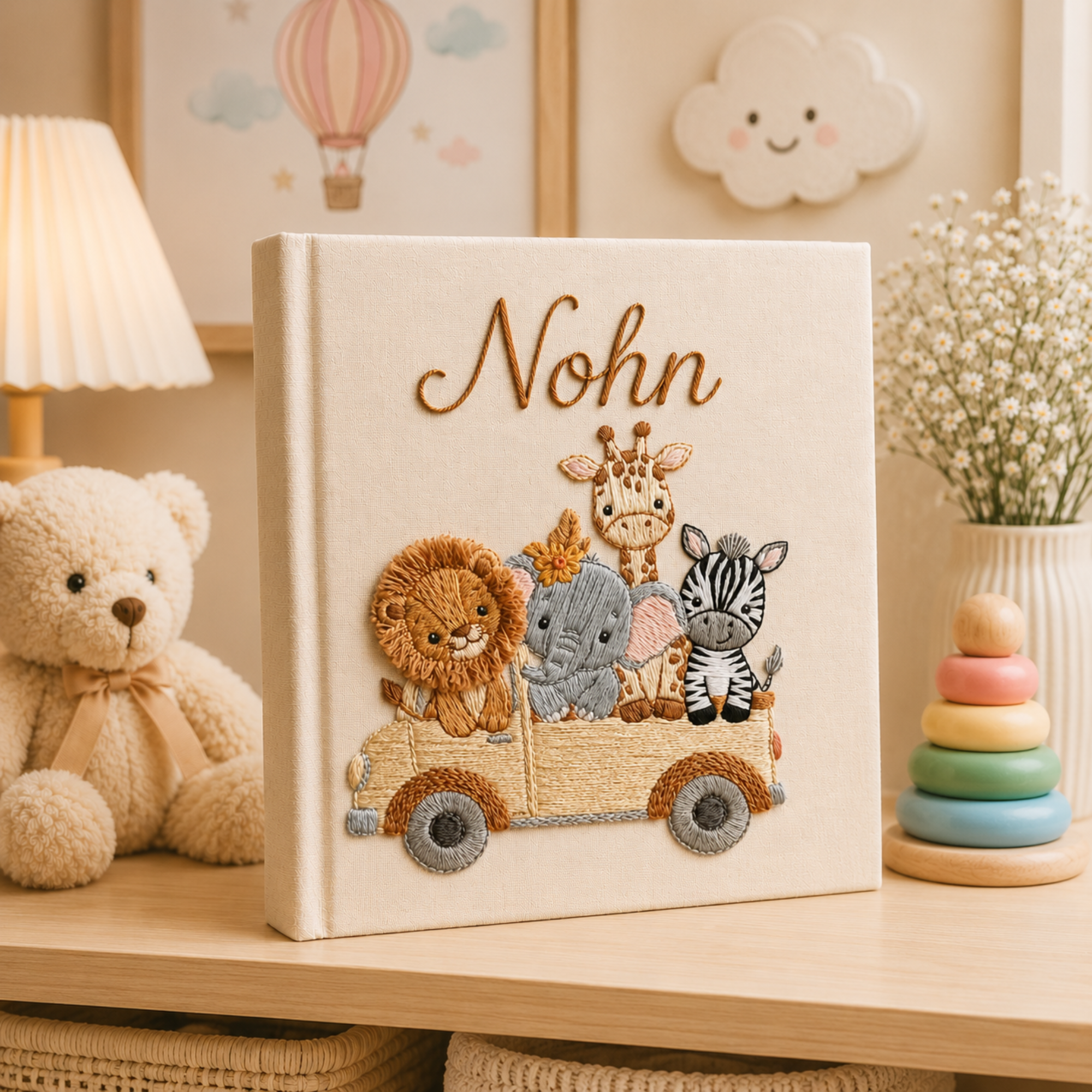 Personalized hand embroidered photo album featuring safari animals including a lion elephant giraffe and zebra riding together in a wooden wagon on a linen cover