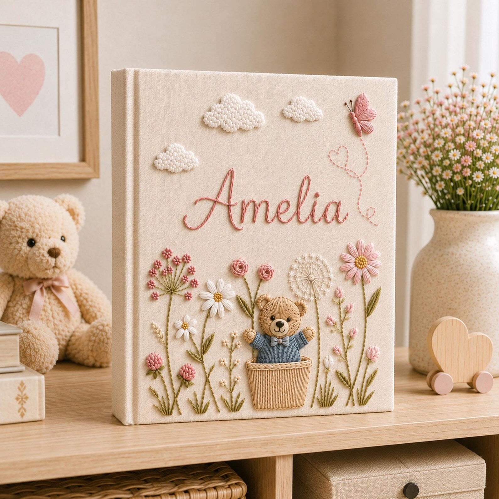Personalized hand embroidered baby photo album with teddy bear, blue flowers, clouds, and butterfly embroidery details