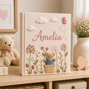 Personalized hand embroidered baby photo album with teddy bear, blue flowers, clouds, and butterfly embroidery details