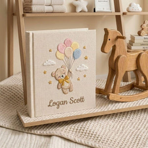 Personalized hand embroidered photo album featuring a floating teddy bear holding pastel balloons with custom baby name embroidery