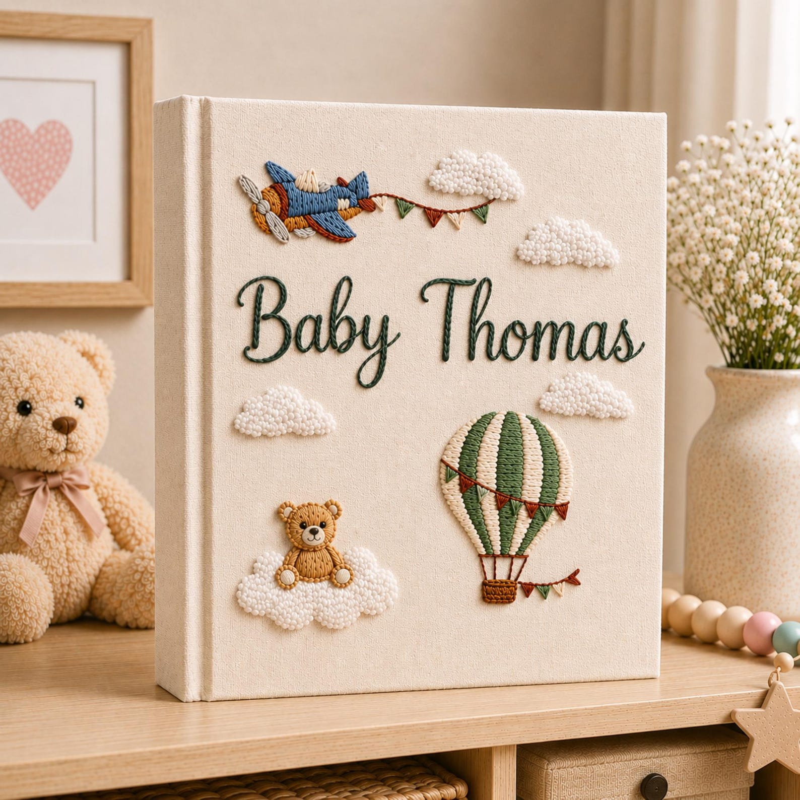Personalized hand embroidered baby photo album with hot air balloon, airplane, clouds, and teddy bear embroidery