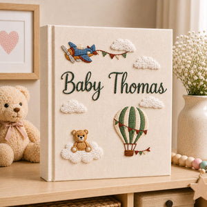 Personalized hand embroidered baby photo album with hot air balloon, airplane, clouds, and teddy bear embroidery