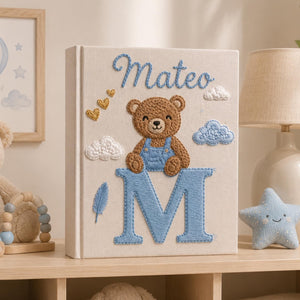 Personalized hand embroidered baby photo album with teddy bear sitting on monogram letter E