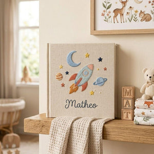 Personalized embroidered baby photo album with space rocket, moon, planets, stars, and custom name embroidery