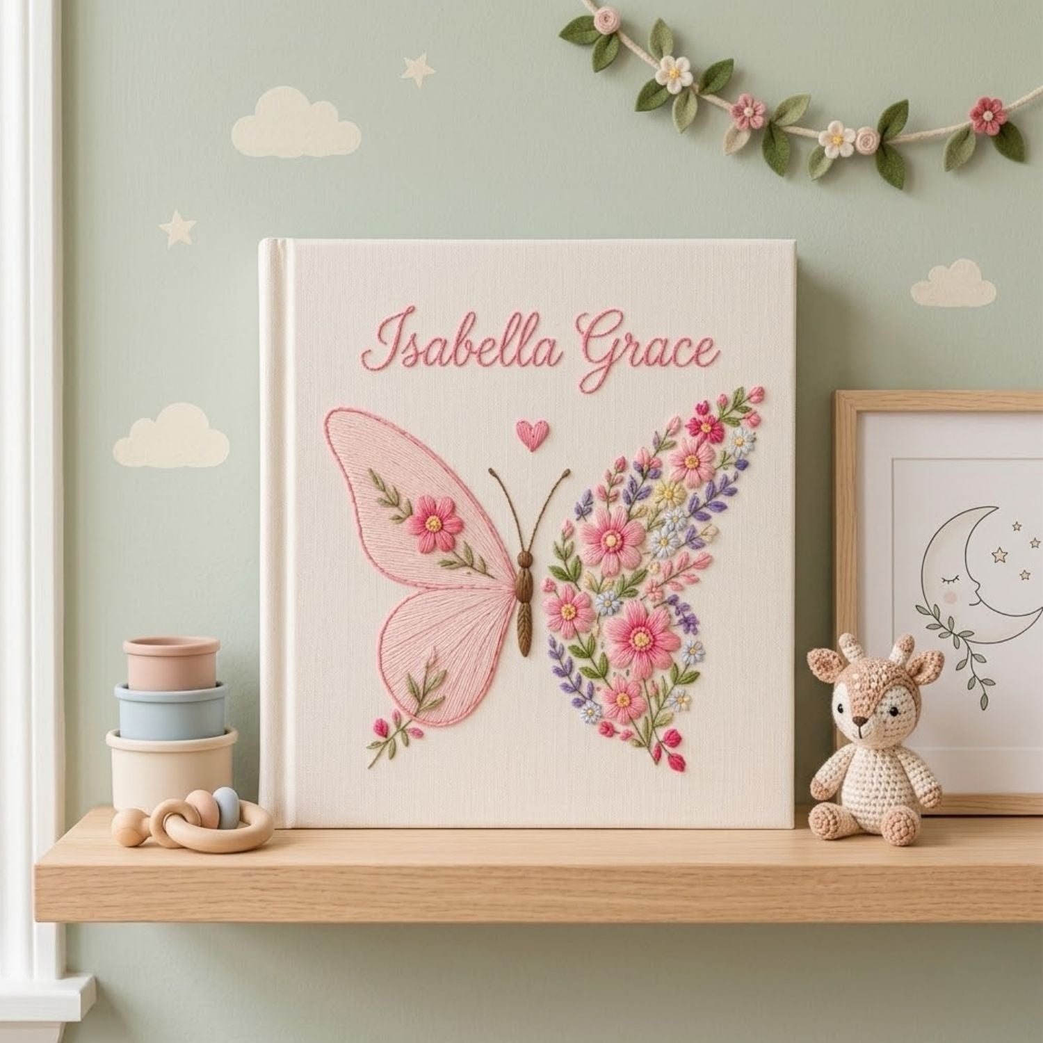 Personalized hand embroidered photo album featuring a floral butterfly with pink wildflowers, lavender accents, and custom name embroidery on a premium linen cover