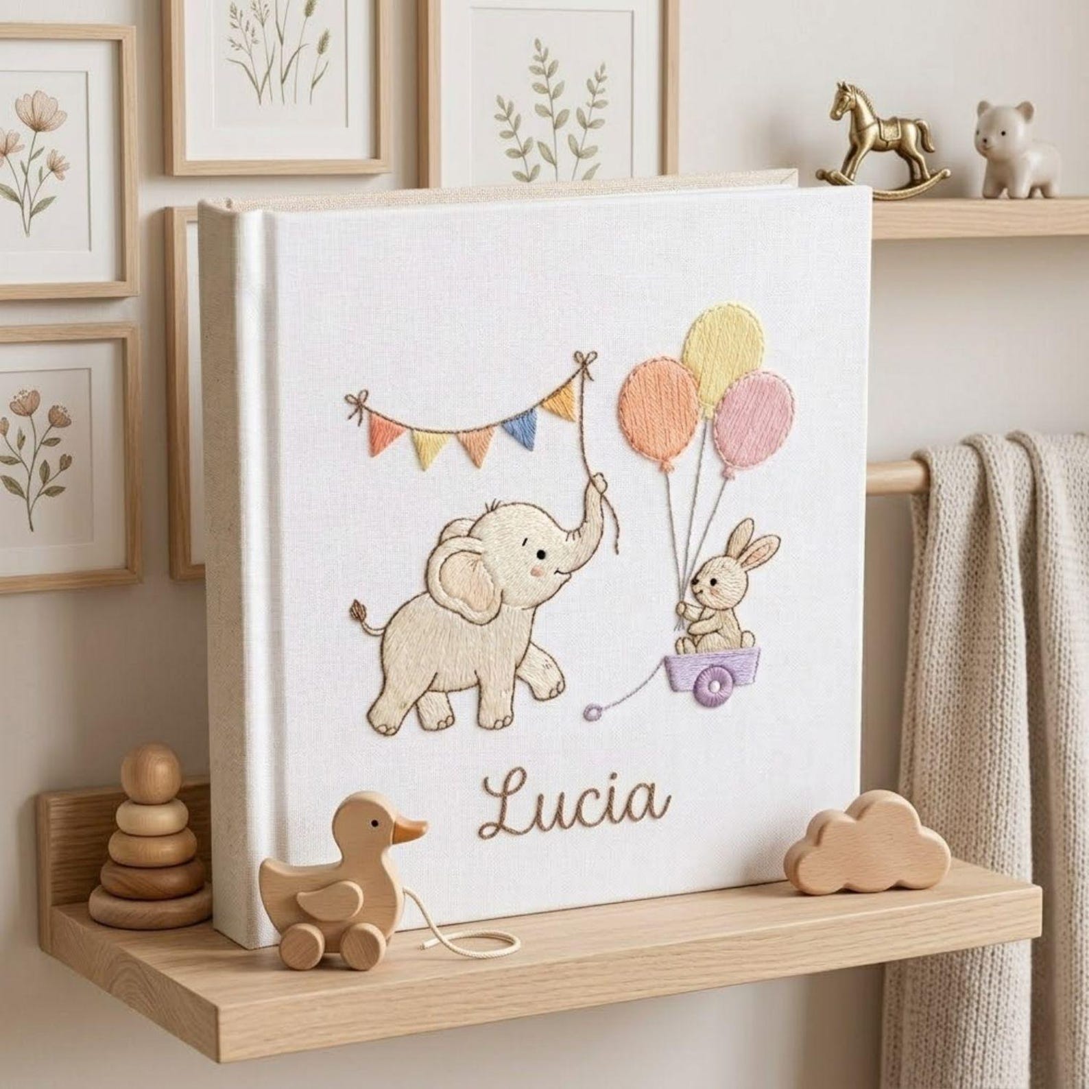 Personalized embroidered baby photo album with elephant, bunny, pastel balloons, and custom name embroidery