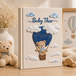 Personalized embroidered baby photo album with teddy bear in blue hot air balloon and fluffy cloud nursery design