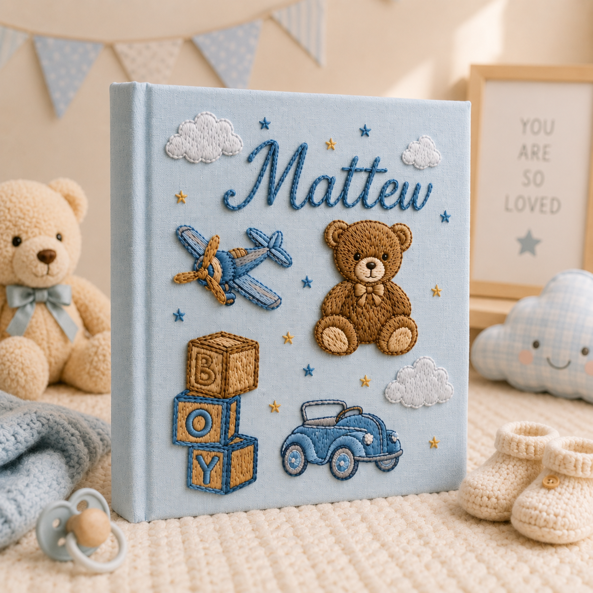 Personalized hand embroidered photo album featuring teddy bear, toy airplane, vintage car, alphabet blocks and nursery stars in blue tones