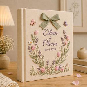 Personalized hand embroidered tulip floral wedding photo album with bow detail and custom couple names on linen cover