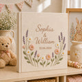 Personalized wildflower embroidered wedding album with lavender stems, pastel daisies, and custom couple names on a linen fabric cover