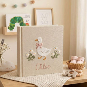 Personalized goose hand embroidered baby photo album with daisy floral cottagecore nursery design on linen cover