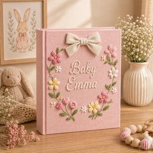Personalized hand embroidered baby photo album with pastel floral wreath embroidery and elegant linen bow detail