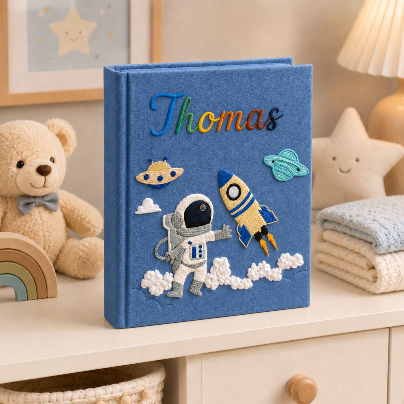 Personalized hand embroidered photo album featuring astronaut rocket ship planets and custom baby name on linen cover
