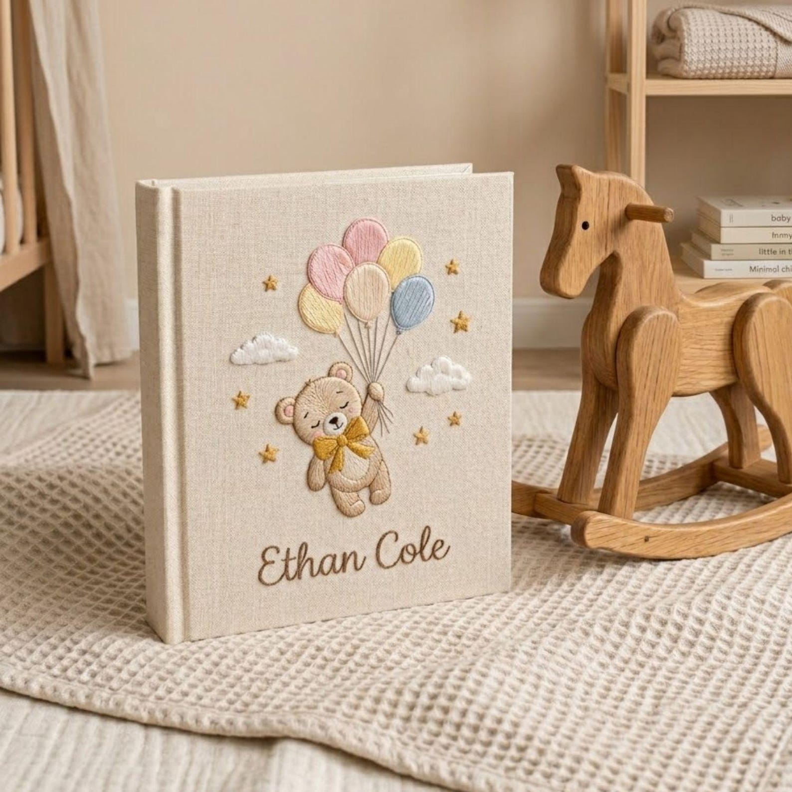 Personalized hand embroidered photo album featuring a floating teddy bear holding pastel balloons with custom baby name embroidery